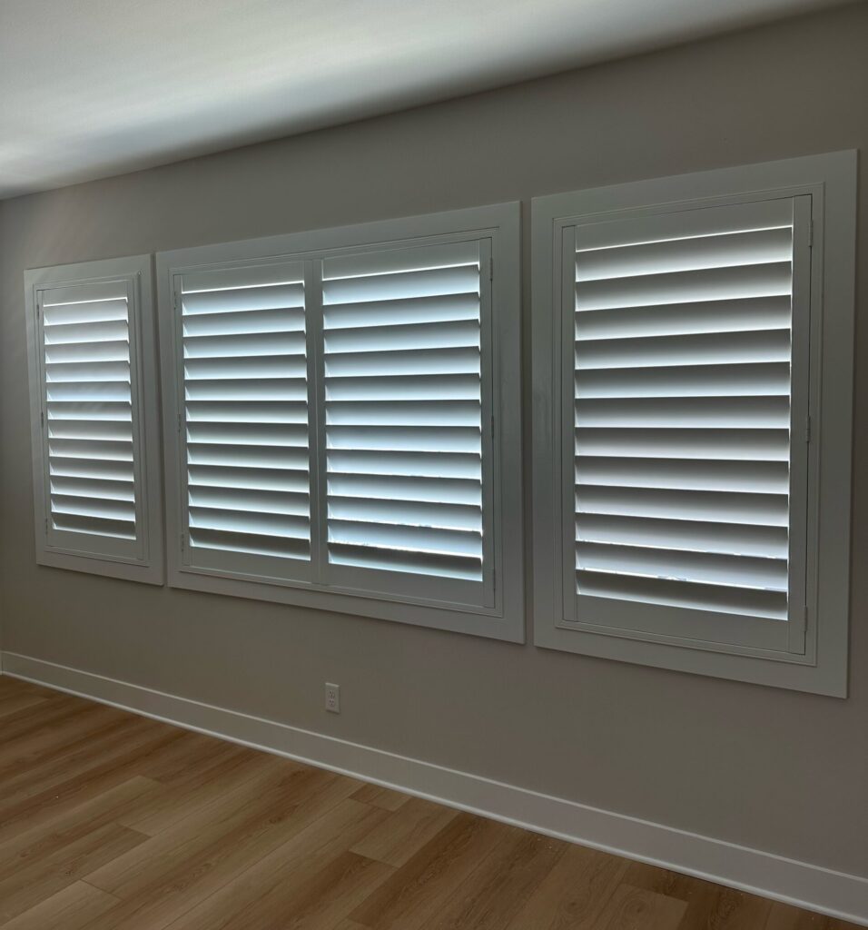 Photo of a large window in Lake Forest, CA with white louvered shutters with hidden tilt